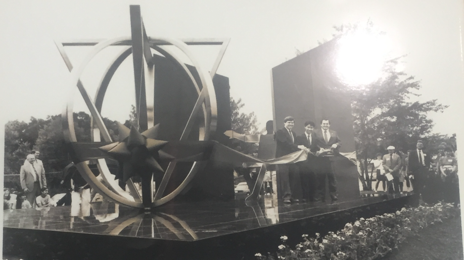 A photo of a photo in Jefferson’s display case. The photo is of the ribbon cutting ceremony held at the first unveiling of Thomas Jefferson High School.