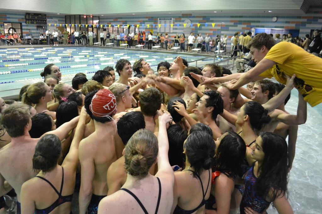 The Thomas Jefferson Swim and Dive Team (TJSD) cheers their way to victory on Friday at the Herndon Community Center.