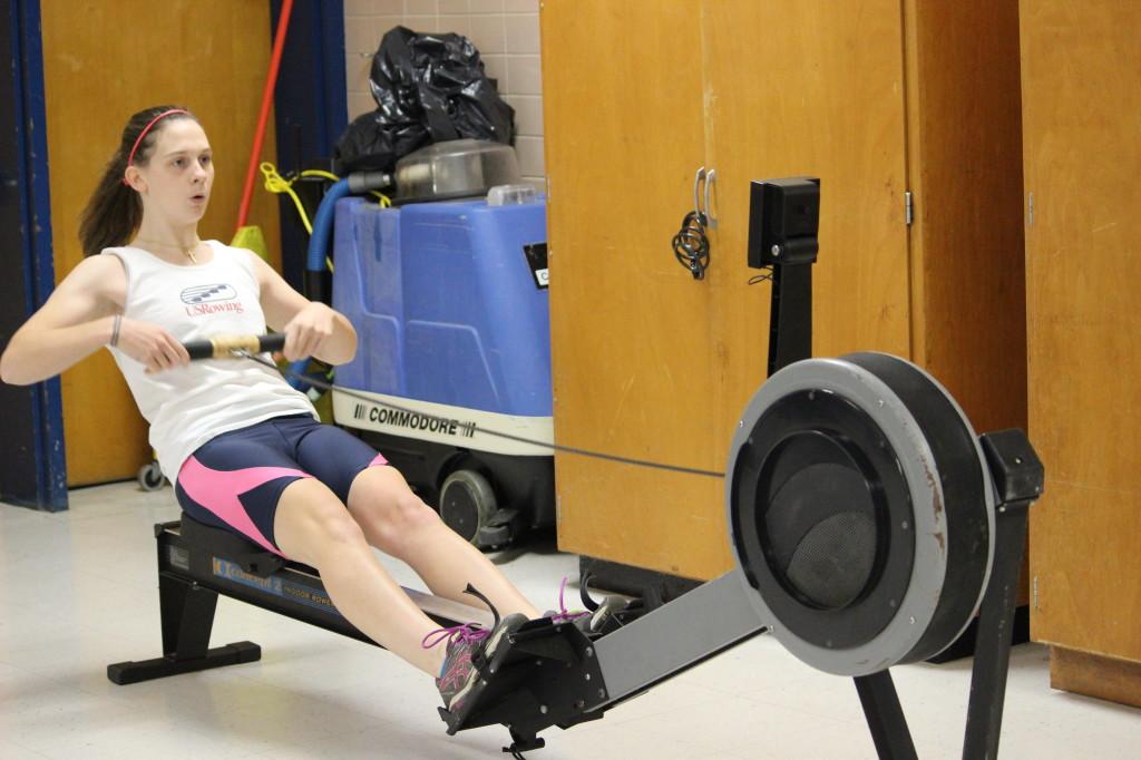 Senior Julia Arthur trains on an erg machine during winter training.