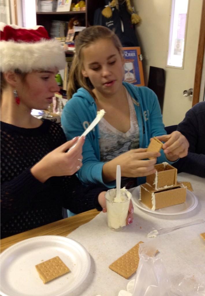 Students build and decorate festive gingerbread houses