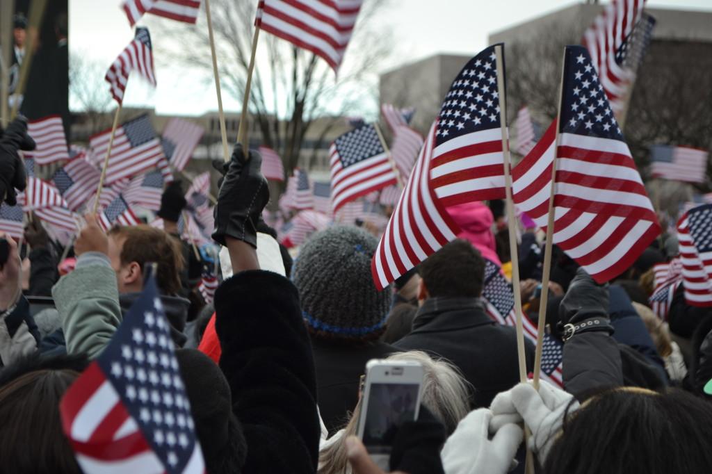 Spectators+wave+flags+while+watching+the+Inauguration.+