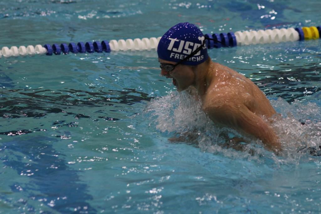 Senior captain Reese Frerichs swims the boys 100-yard breaststroke at the Northern Region Swimming and Diving Championships.