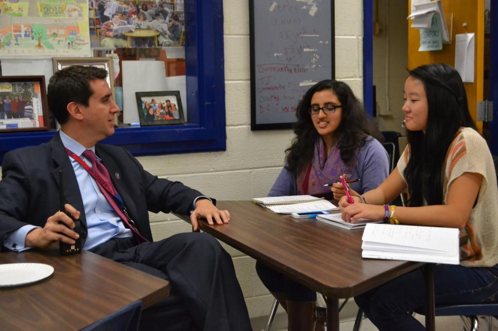 Principal Evan Glazer talks to seniors Mallika Patkar and Jenny Chen.