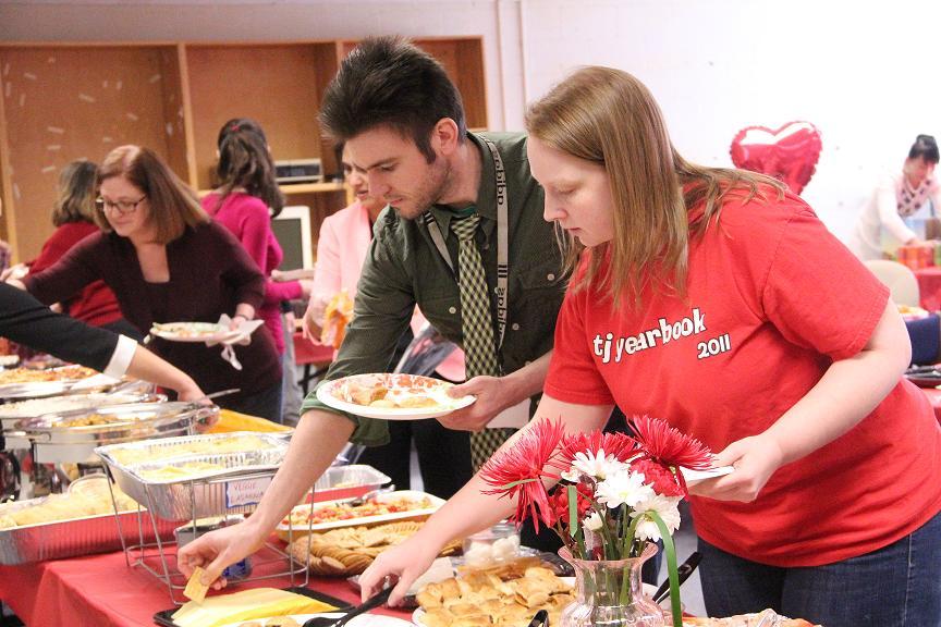 English teacher Erinn Harris and Communications Systems Research lab director Paul Kosek choose from the dishes provided by the PTSA for the Valentine's Day lunch.