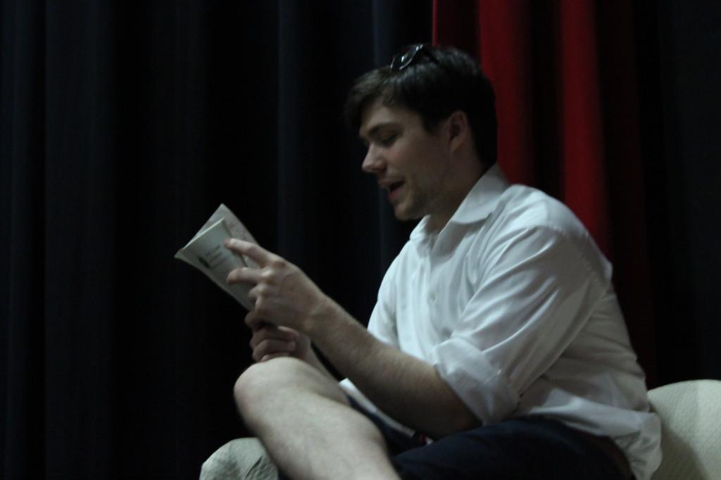 Guest director Zach Roberts reads from the script during a rehearsal.