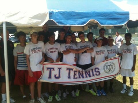 The boys tennis team smile for the camera after defeating Langley High School at the Virginia AAA state championship.