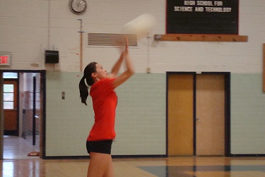 During a scrimmage, sophomore Valerie Chen serves the ball.