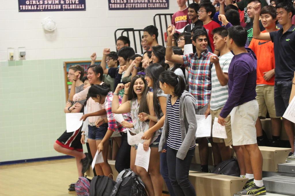 Juniors practice their cheer on the bleachers in Gym 2 at the Homecoming class meeting.