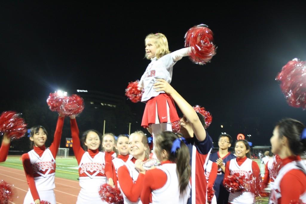 Stunting with Jefferson cheerleaders at the TJ vs. Marshall football game