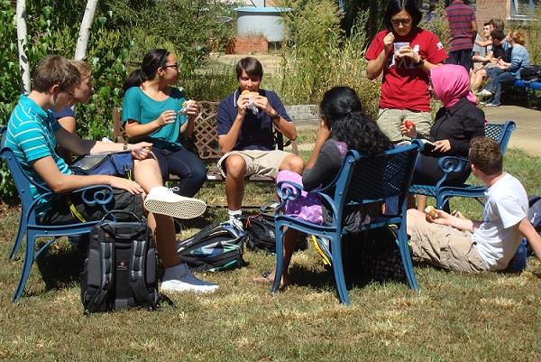 Students can eat at the café while sitting on chairs or benches.