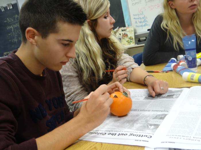 French student Nathan Cocquelet paints a pumpkin at the FHS meeting.