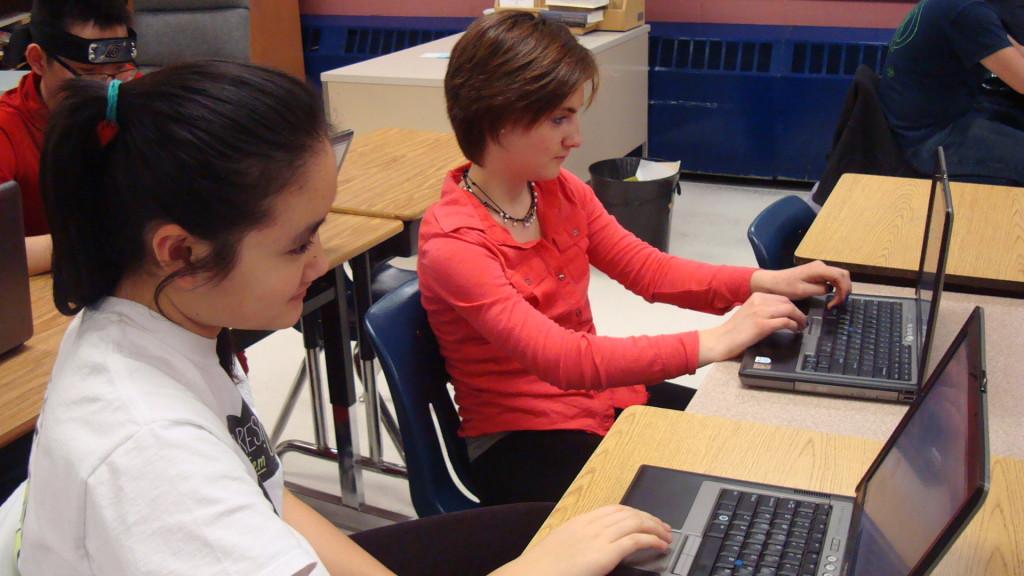 Sophomores Sherry Wang and Phoebe Whitmore participate in various activities, such as taking a survey, to learn more about child slavery.