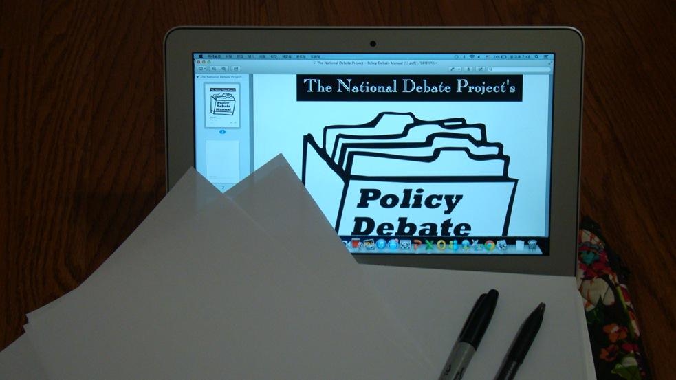 During a Policy debate round, most students use their laptops, papers, and pens to keep track of their opponent's arguments and offer evidence that opposes them.