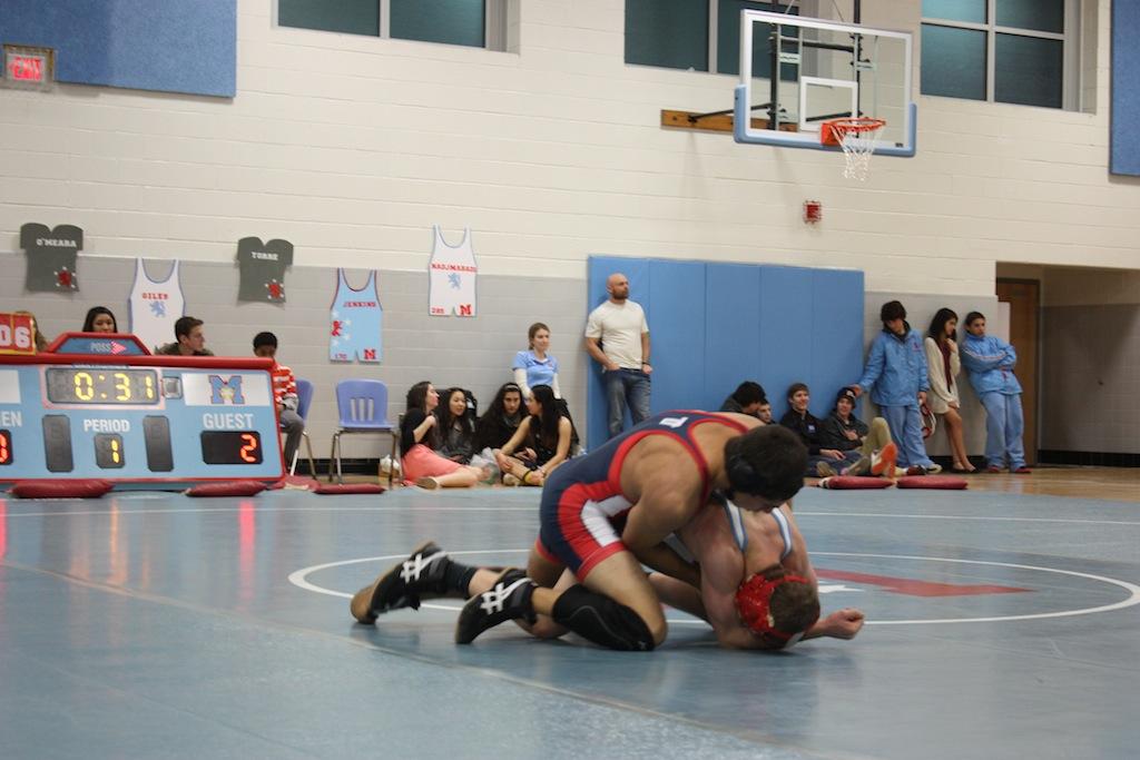 Senior Arvind Gupta wrestles for the Jefferson team in the last meet of the season at Marshall High School.