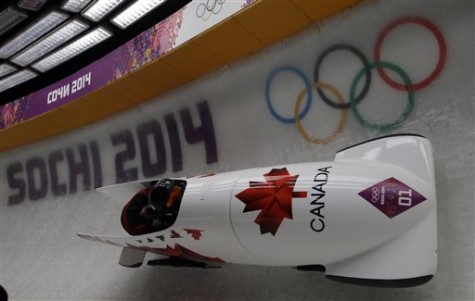 The team from Canada CAN-1, piloted by Kaillie Humphries with brakeman Heather Moyse, speed down the track in their final run during the women's bobsled competition at the 2014 Winter Olympics, Wednesday, Feb. 19, 2014, in Krasnaya Polyana, Russia. The team won the gold medal. (AP Photo/Dita Alangkara)