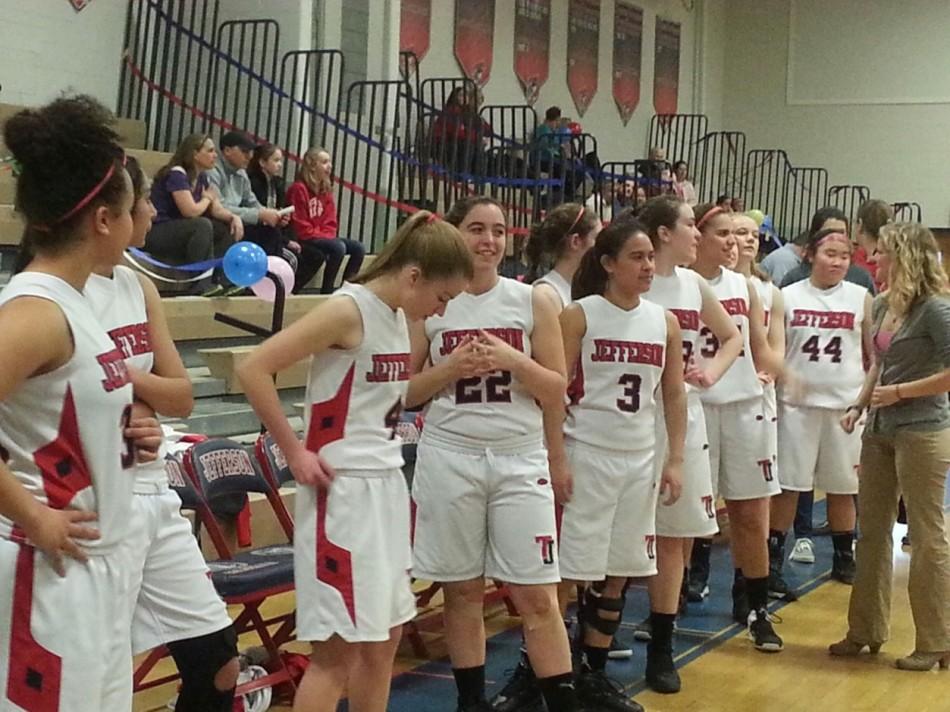 The varsity players in the Jefferson girls' basketball team prepares for the game against Stuart High School after the senior night.