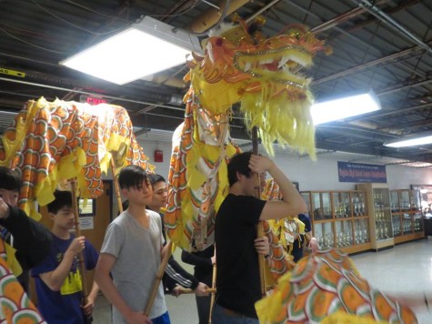 Chinese Honor Society dragon group rehearses using their puppet.
