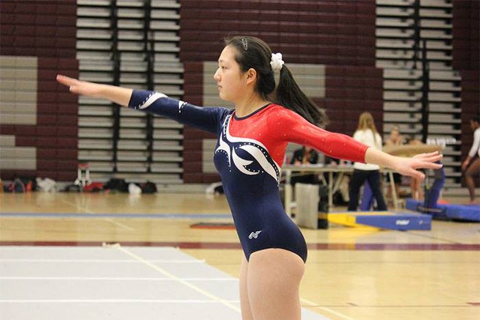 Junior Jenny Fang completes her floor routine at the Capitol Conference Championship.