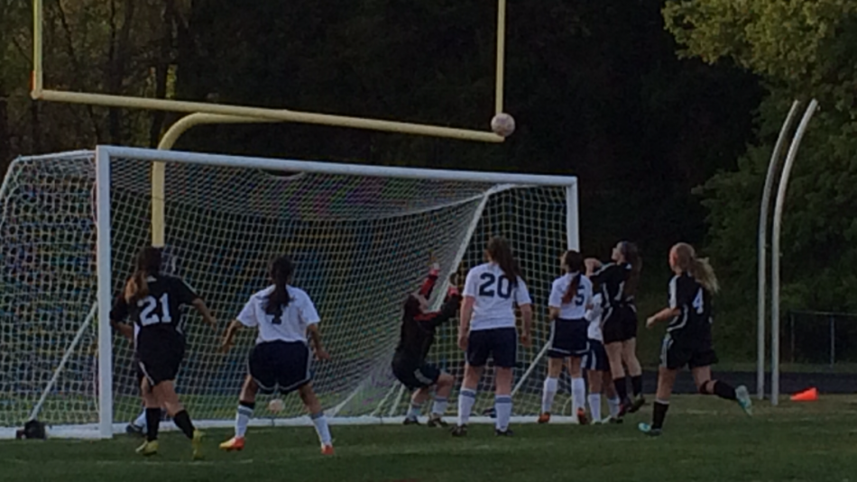 Junior varsity goalie, freshman Raquel Sequeria, saves a shot from the Chantilly striker. 