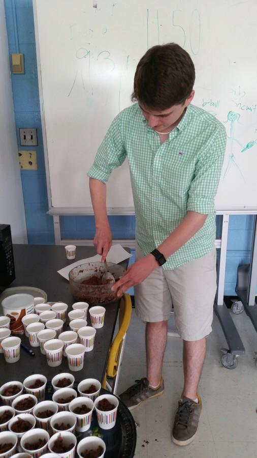 Junior Gavin Moore, a member of RHS, mixes the chocolate in a bowl for the truffles during eighth period on June 11.