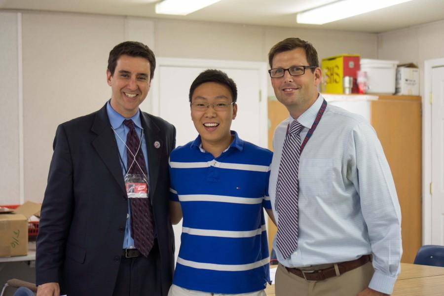 Principal Evan Glazer (left) and Assistant Principal Shawn DeRose (right) surprised rising senior Brandon Kim (center) in his fourth period exam period when they announced that his submission had won the One Question contest.