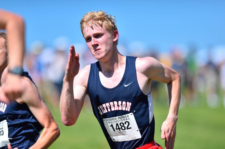 Senior Mitch Woodhouse sprints to the finish at the end of the varsity boys' race.
