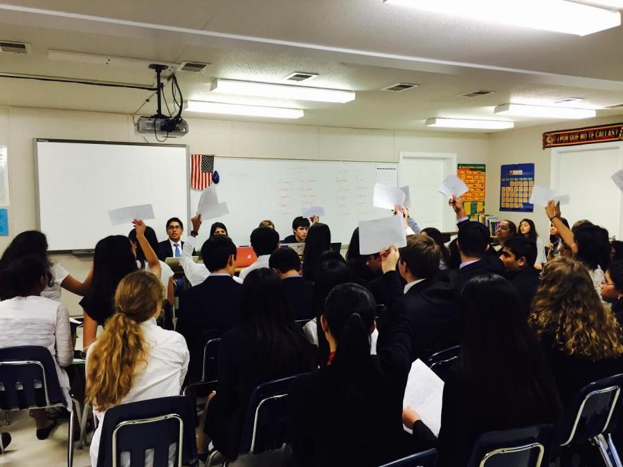 Delegates of Jefferson's Model United Nations (TJMUN) raise their placards at the mock Model United Nations Conference on Oct. 17.