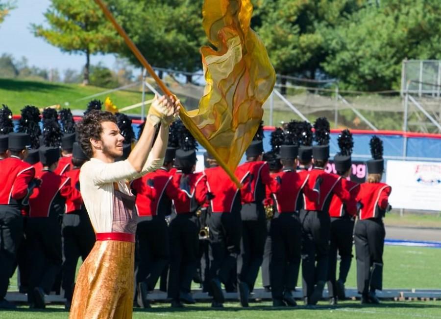 Senior Edi Danalache performs with color guard in Saturday's competition.