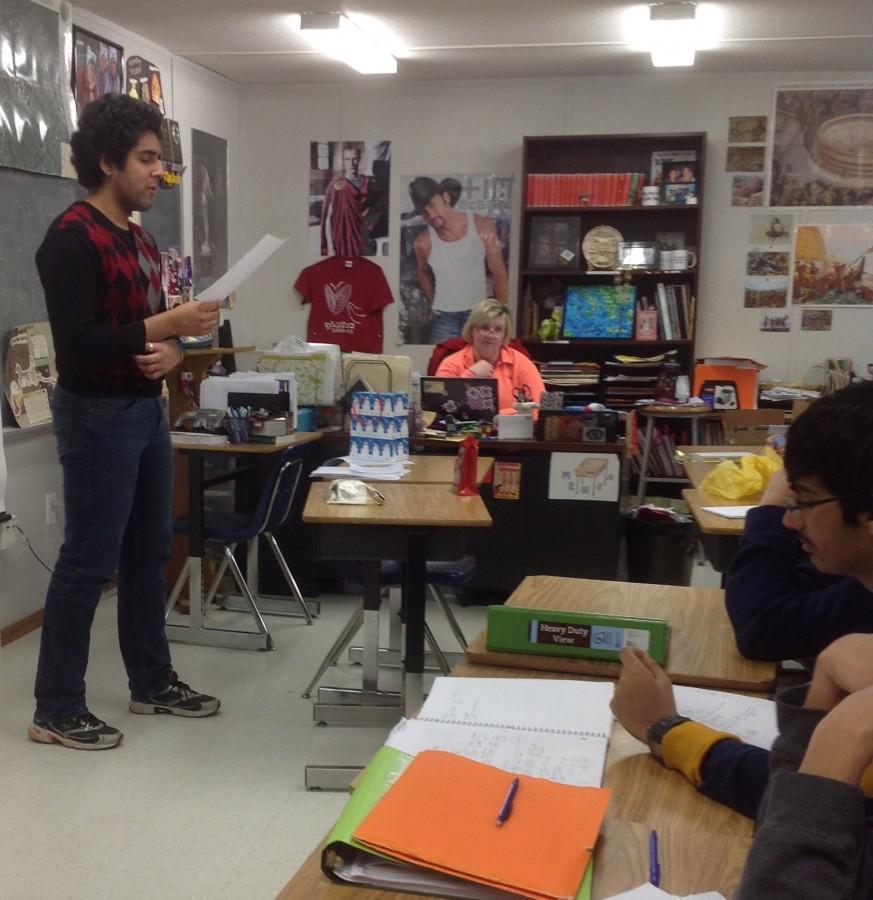 Senior Anant Das reads his poem to the class during Saturnalia celebrations.