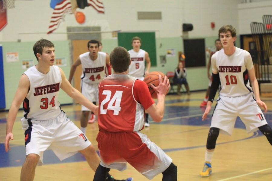 Seniors Seth Jaffe and Ryan Morris try to block a player from the McLean Highlanders.