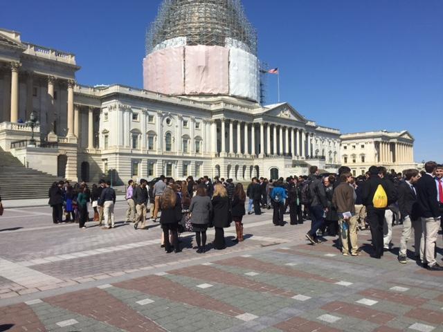 Seniors congregate in front of the Capitol to hear Representative Don Beyer speak.