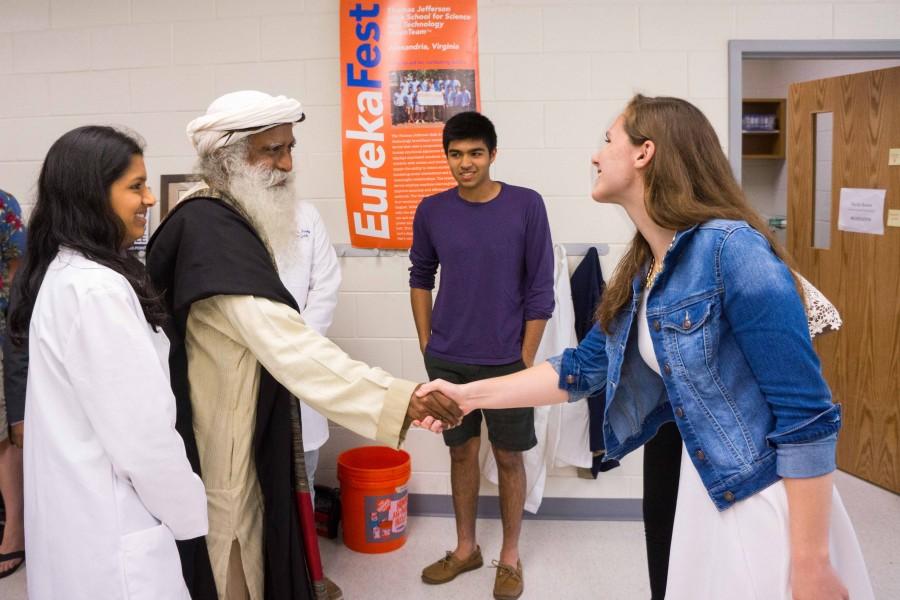 Senior Callan Monette, a member of the Neuroscience Laboratory, shakes hands with Sadhguru before presenting her project.