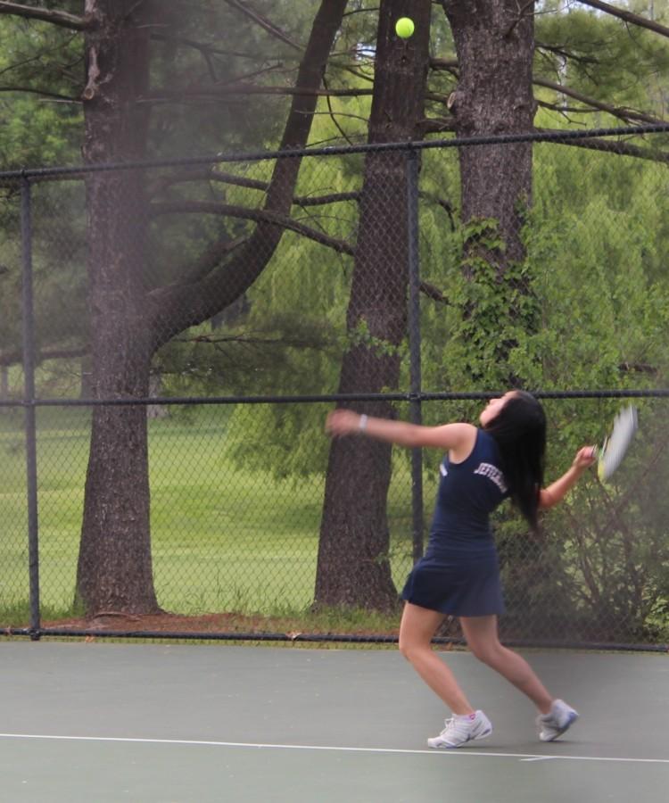 Freshman Keely Wan returns a hit.