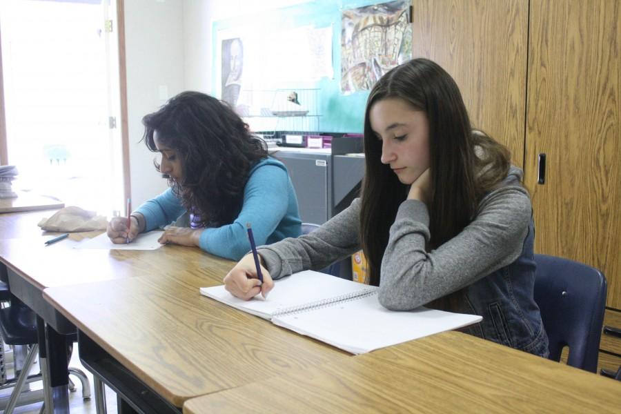 Sophomore Anusha Balani and freshman Anna Lulushi stress-write alongside other students during A Block on May 1.