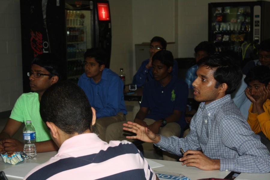Senior Ani Chandrabhatla gives feedback on a team's product.