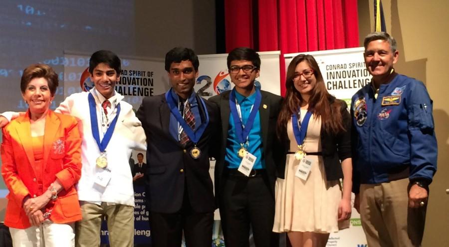 From left to right: founder and chairman Nancy Conrad, sophomore Rohan Suri, junior Kevin Livingstone, sophomore Varun Iyengar, junior Claire Scoggins and former NASA astronaunt Robert Cabana celebrate the team behind Suri Labs being recognized as Pete Conrad scholars.