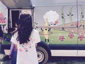 Students stand outside of food trucks during lunch to buy a meal.