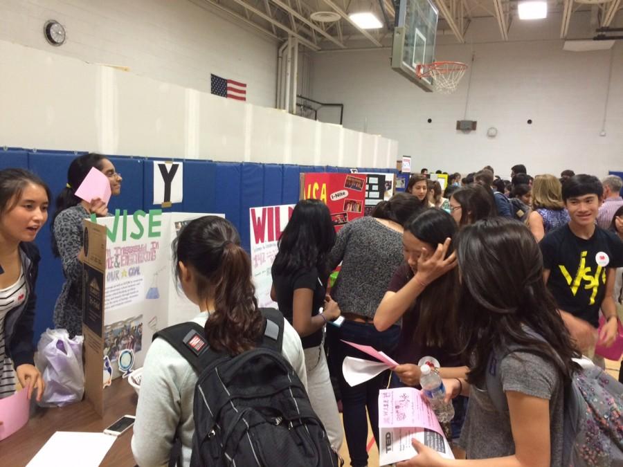 Representatives at club booths in Gym 2 talk with new students about the many activities Jefferson has to offer.