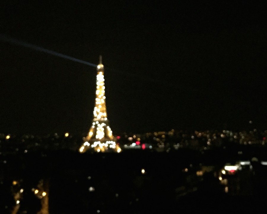 The Eiffel Tower lights up in Paris when the sky turns dark.