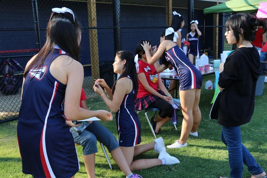 The cheerleading squad face paints students during the Back-to-School Bash