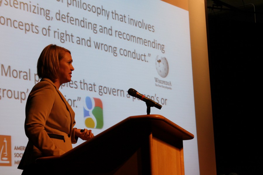 Keynote speaker Dr. Davies speaks in the auditorium about research that violated ethical and moral standards.