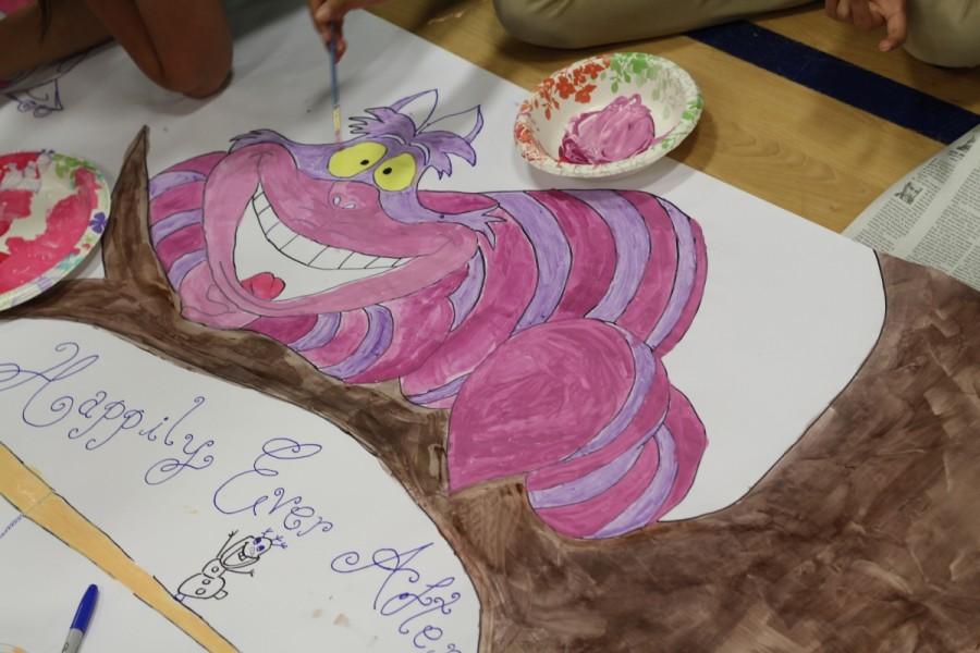 Juniors paint the Cheshire Cat from "Alice in Wonderland" to match their class theme of "Bedtime Stories"