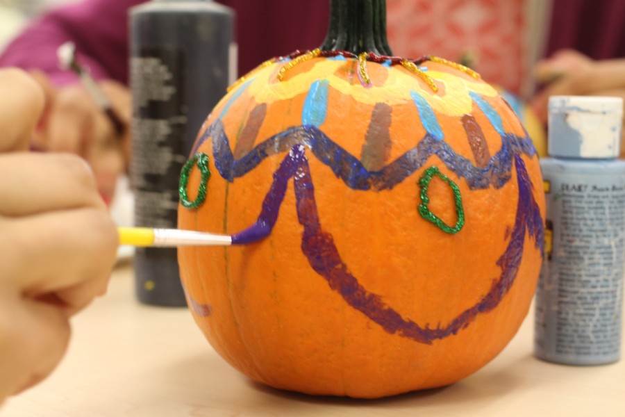 Sophomore Sharmila Roy (not pictured) continues to paint an intricate design for her pumpkin during Rotary Interact