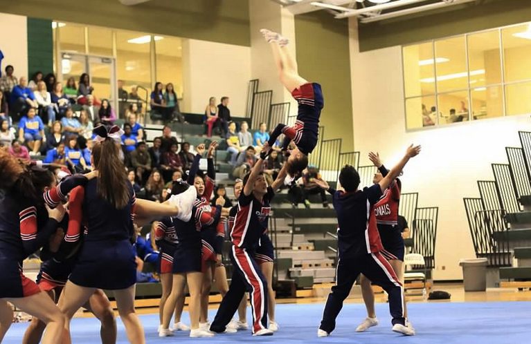 The+Jefferson+cheer+team+performs+a+handstand+vault+over+to+pyramid+during+their+routine+at+the+Capitol+Conference+on+Oct.+26
