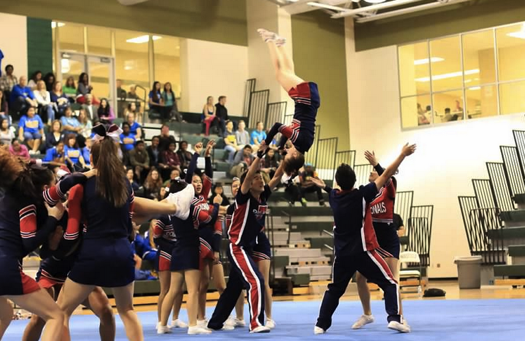 The Jefferson cheer team performs a handstand vault over to pyramid during their routine at the Capitol Conference on Oct. 26