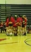 The Varsity Volleyball team huddles before the game begins.