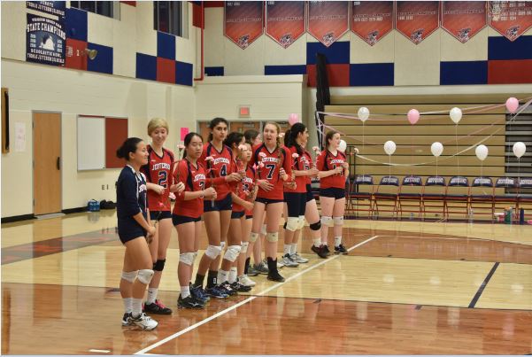 Team waits while both teams are being introduced.