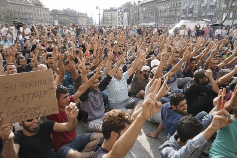 Refugees strike outside a railway station in Budapest. European nations have varied greatly in their reception of refugees. Some, like Hungary, are closing their doors and urging nations such as Germany to follow suite. 