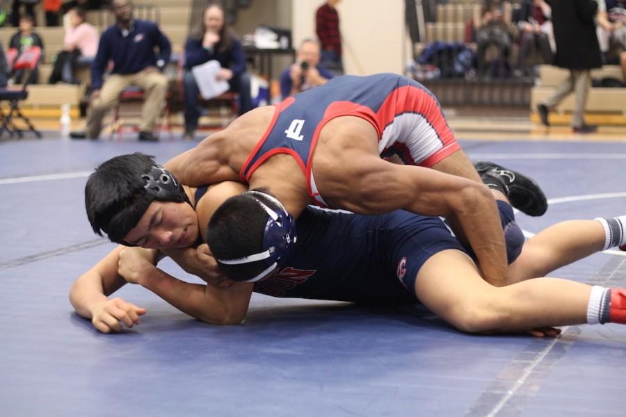 Celebrating his senior night match, Vikram Gupta successfully pins Edison.