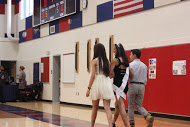 Senior Cece Xiao walks across the gym with escorts, senior Helen Ngov and junior Chris Cao as she is recognized as a senior dance team member.